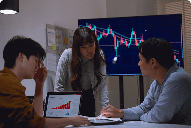 Group reviewing business data on computer