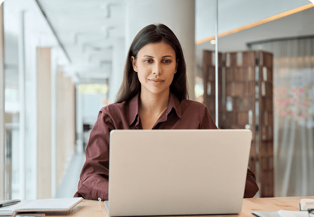 Businesswoman using laptop at desk